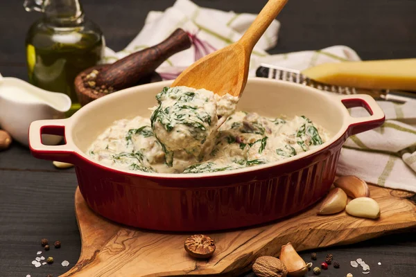 Delicious meatballs with spinach in a creamy sauce in baking dish — Zdjęcie stockowe