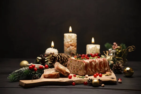 Traditional French terrine covered with bacon and Christmas decoration on dark wooden background — Stock Photo, Image