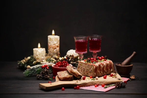 Traditional French terrine covered with bacon on dark wooden background with Christmas decorations — Stock Photo, Image