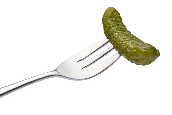 Tasty canned Whole green cornichon on a fork isolated on a white background — Stock Photo, Image