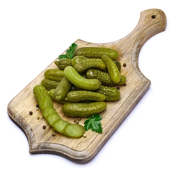 Tasty Whole green cornichons on wooden serving board isolated on a white background — Stock Photo, Image