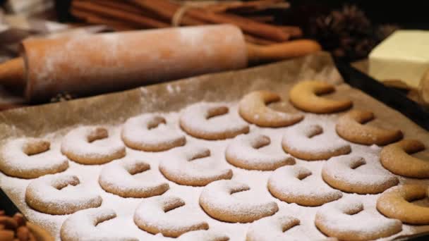 Woman sprinkles sugar powder on traditional German or Austrian Vanillekipferl vanilla kipferl cookies — Stock Video