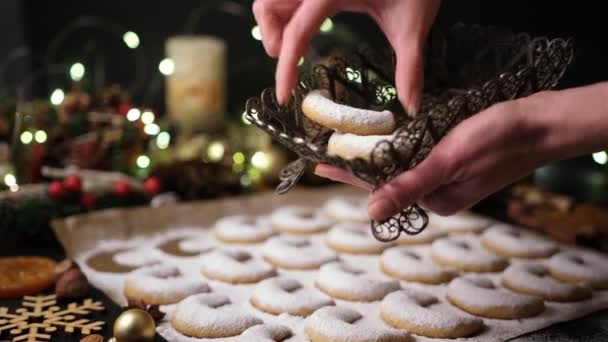 Woman puts Traditional German or Austrian Vanillekipferl vanilla kipferl cookies in a basket — Stock Video