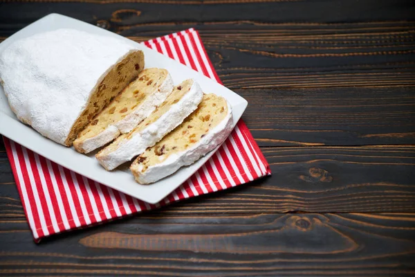 Pastel tradicional de Navidad en rodajas con mazapán y fruta seca sobre fondo de madera —  Fotos de Stock