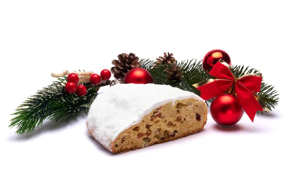 Sliced Traditional Christmas stollen cake with marzipan and dried fruit with New Year decorations — Stock Photo, Image