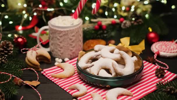 Woman puts traditional German or Austrian Vanillekipferl vanilla kipferl cookies in a gift box — Stock Video