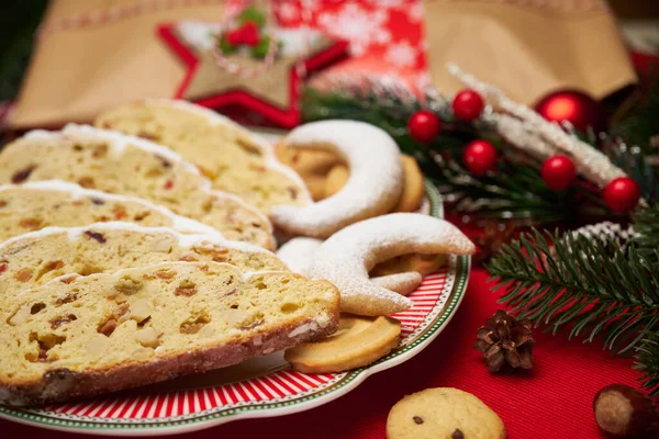 Slices of Traditional Christmas stollen cake with marzipan and New Year decorations — Stock Photo, Image