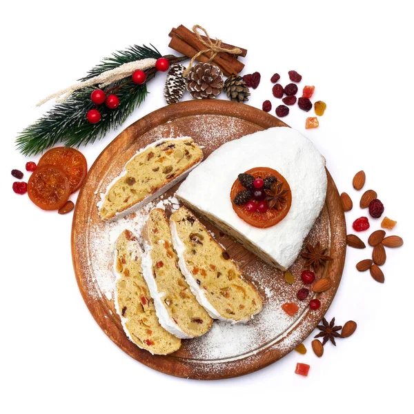 Sliced Traditional Christmas stollen cake with marzipan and dried fruit isolated on white background — Stock Photo, Image