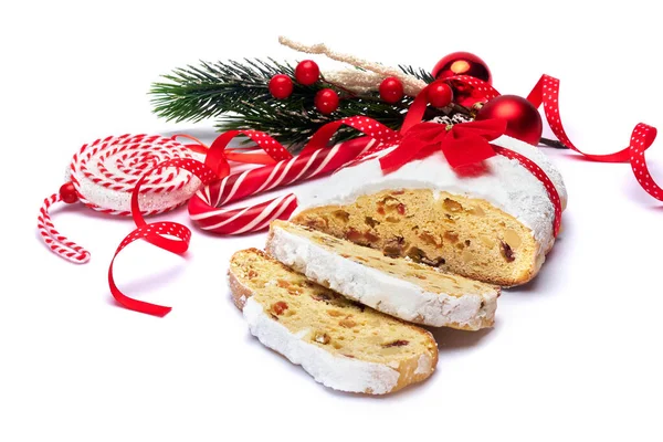 Sliced Traditional Christmas stollen cake with marzipan and dried fruit isolated on white background — Stock Photo, Image