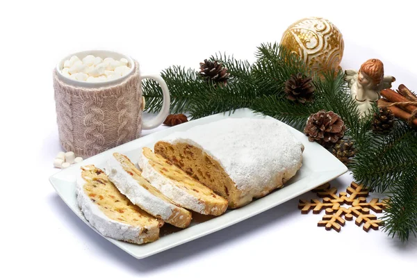 Sliced Traditional Christmas stollen cake with marzipan and dried fruit isolated on ceramic plate — Stock Photo, Image