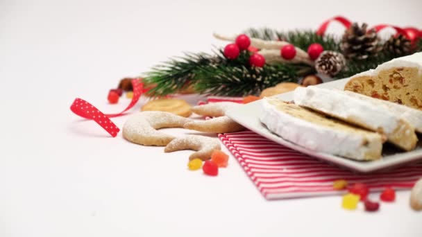 Sliced Traditional Christmas stollen cake on ceramic plate and New Year decorations — Stock Video