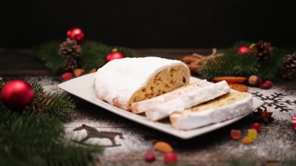 Sliced Traditional Christmas stollen cake with marzipan and dried fruit on wooden background — Stock Video