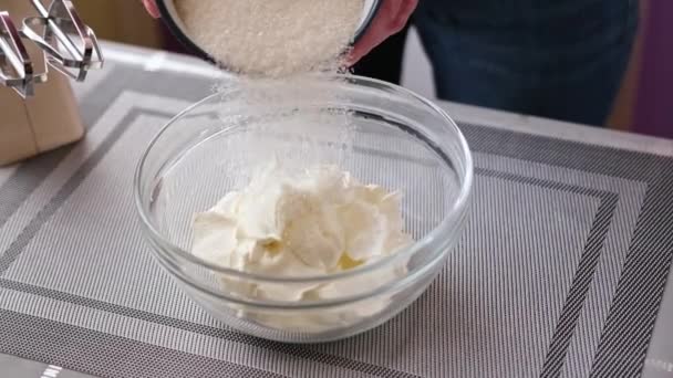 Making cream for cake - γυναίκα βάζει ξινή κρέμα και sugarin χτυπώντας μπολ — Αρχείο Βίντεο