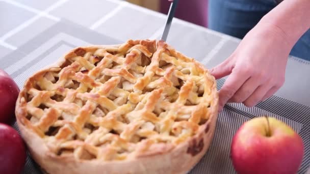 Apple pice cake preparation series - woman slicing pie on a table - top view — Video