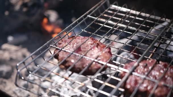 Beef burgers cutlets are roasting on the charcoal barbecue grill — Stock video