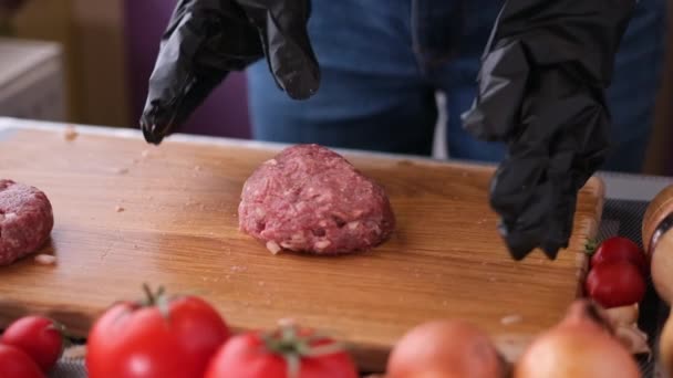 Vrouw slaat gehakt vlees voor het koken koteletten op houten snijplank — Stockvideo