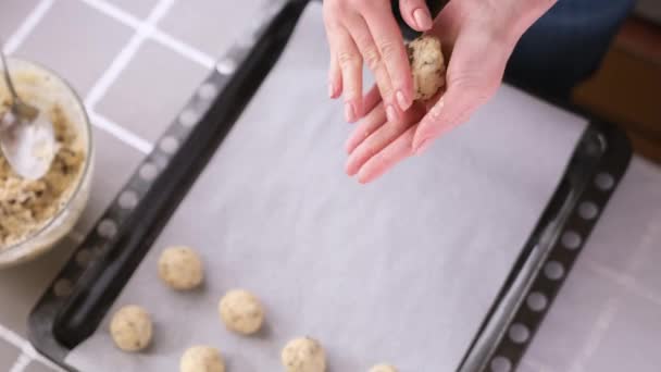 Making chocolate cookies - Woman is rolling the ball of dough - Baking at home — Stockvideo