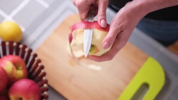 アップルパイ準備シリーズ 女性はナイフでリンゴを剥離しています — ストック動画