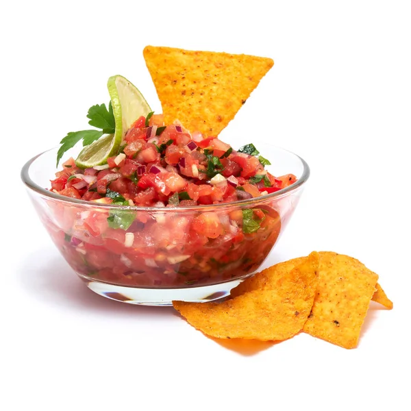 Glass bowl of tomato salsa dip with Tortilla chips isolated on white background.
