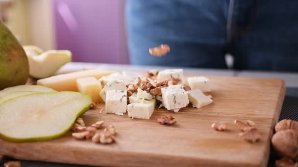 Making Pear Blue Cheese Salad Walnuts Falling Wooden Cutting Board — Stockvideo