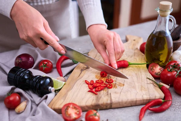 Woman Cuts Fresh Red Chili Peppers Wooden Cutting Board Domestic — Fotografia de Stock