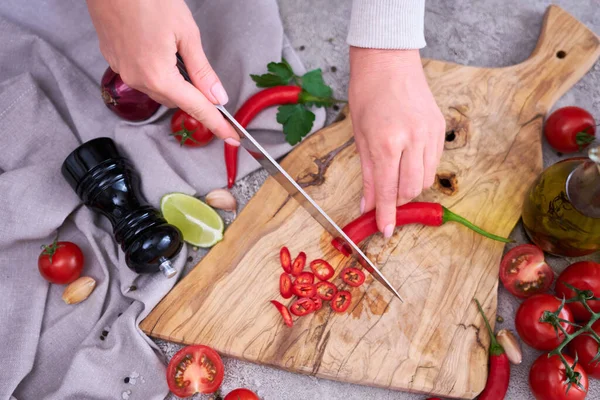 Woman Cuts Fresh Red Chili Peppers Wooden Cutting Board Domestic — Fotografia de Stock