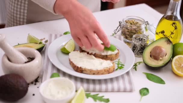 Woman Prepares Healthy Breakfast Snack Soft Cheese Sandwich Avocado — Stockvideo