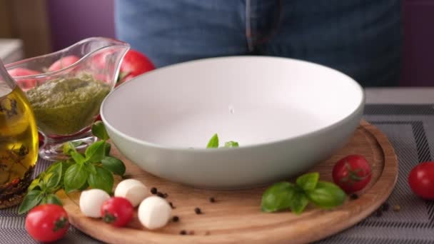 Making Caprese Salad Fresh Basil Leaves Falling Ceramic Dish — ストック動画
