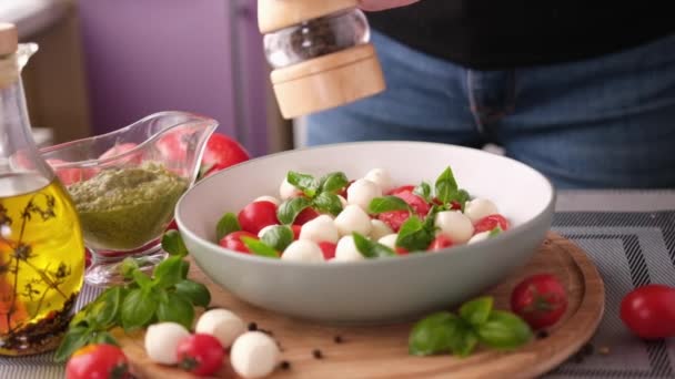 Pouring Grinded Pepper Caprese Salad Mozzarella Cheese Balls Sliced Cherry — Vídeo de stock