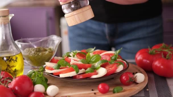 Pouring Grinded Pepper Caprese Salad Mozzarella Cheese Balls Sliced Cherry — Vídeos de Stock