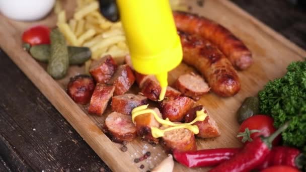 Pouring Mustard Sauce Tasty Grilled Sausages Wooden Serving Board French — Stock videók