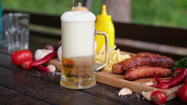 Pouring Beer Glass Mug Tasty Grilled Sausages Background — Vídeos de Stock