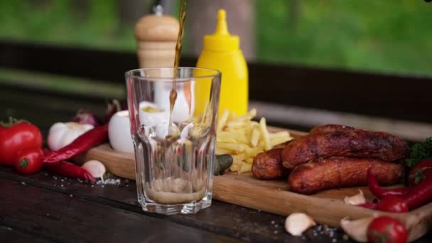 Pouring Soda Drink Glass Tasty Grilled Sausages Background — Stok Video