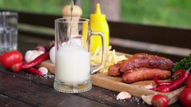 Pouring Beer Glass Mug Tasty Grilled Sausages Background — Stok video