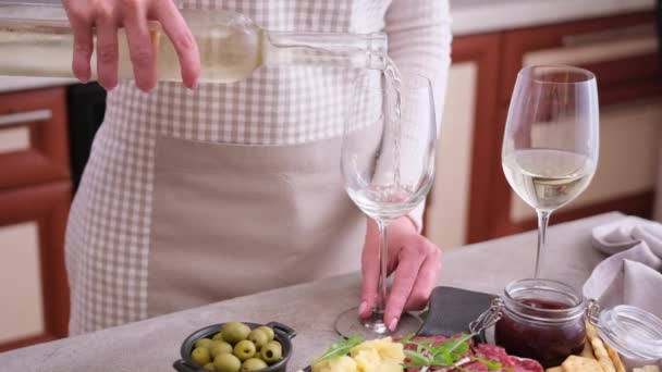 Woman Pouring Wine Glass Bottle Domestic Kitchen Meat Cheese Plater — Stockvideo