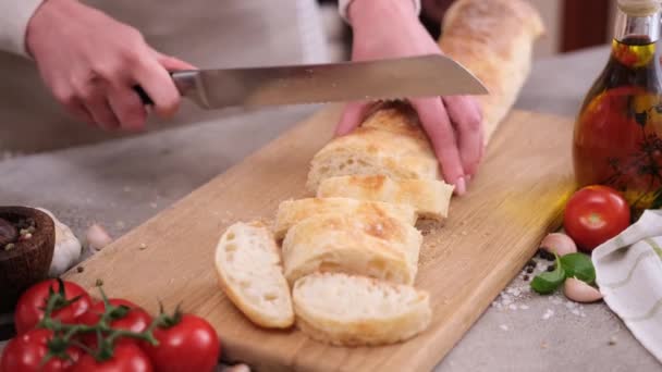 Woman Slicing Baguette Wooden Cutting Board Domestic Kitchen — Stockvideo