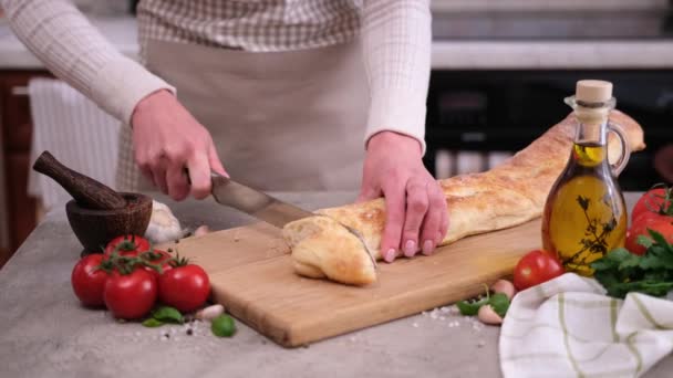 Woman Slicing Baguette Wooden Cutting Board Domestic Kitchen — Stockvideo