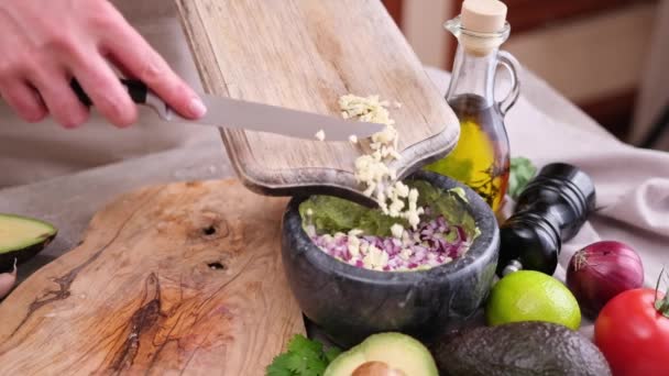 Making Guacamole Sauce Woman Pouring Chopped Garlic Bowl Mashed Avocado — Vídeos de Stock