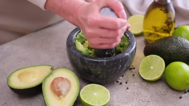 Making Guacamole Sauce Woman Mashing Avocado Marble Mortar Pestle Domestic — Stockvideo