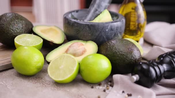 Guacamole Ingredients Avocados Limes Whole Cut Concrete Table Marble Mortar — Stockvideo