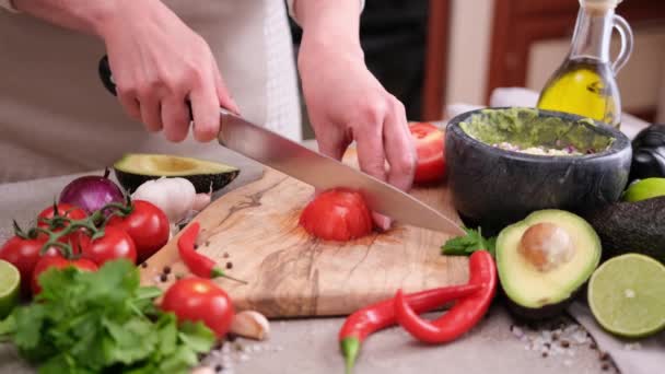 Making Guacamole Sauce Woman Slicing Tomato Wooden Cutting Board — Stock video