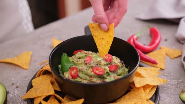 Woman Dips Nachos Chips Freshly Made Guacamole Dip Sauce Marble — Stockvideo