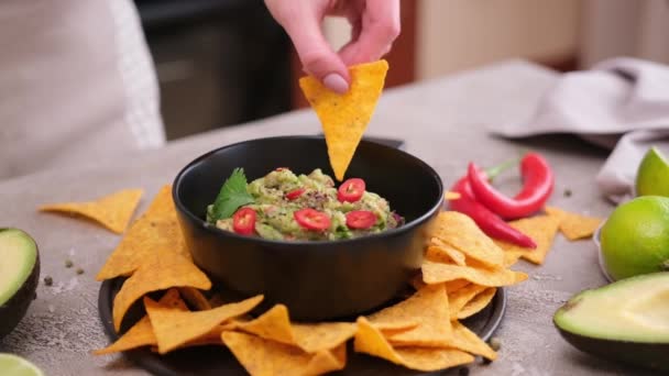 Woman Dips Nachos Chips Freshly Made Guacamole Dip Sauce Marble — Stockvideo