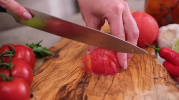 Woman Cutting Peeled Tomato Using Kitchen Knife — Stockvideo