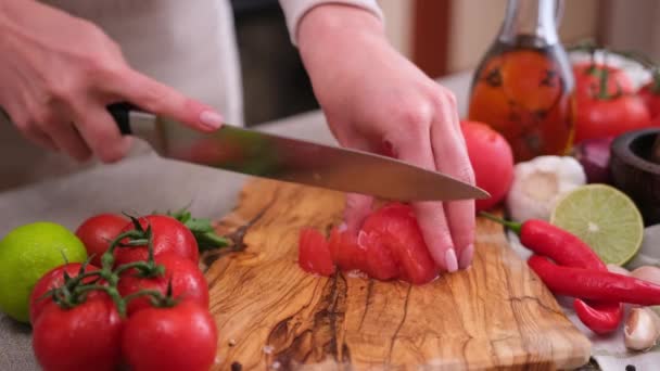 Woman Cutting Peeled Tomato Using Kitchen Knife — Stockvideo