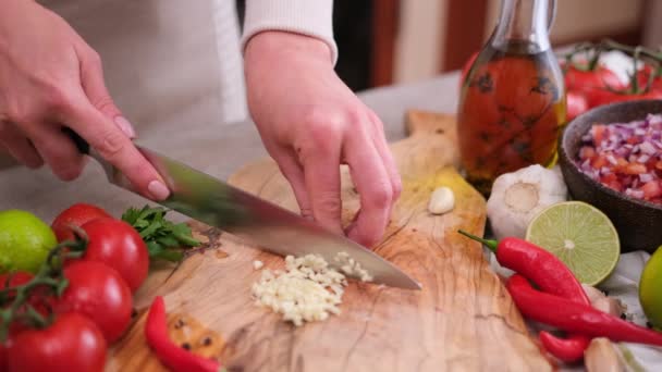 Woman Slices Garlic Kitchen Board Using Knife — Vídeo de Stock