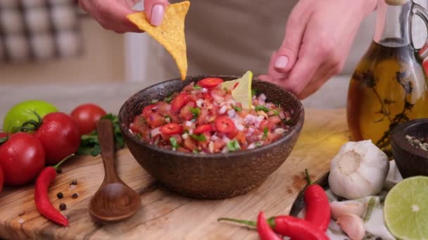 Woman Puts Nacho Chip Salsa Dip Sauce Wooden Bowl — Stockvideo