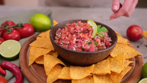 Woman Puts Nacho Chip Salsa Dip Sauce Wooden Bowl — Stockvideo