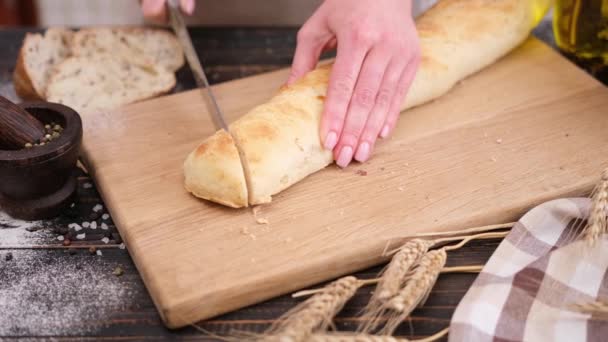 Woman Slicing Fresh Baguette Bread Wooden Cutting Board — Wideo stockowe