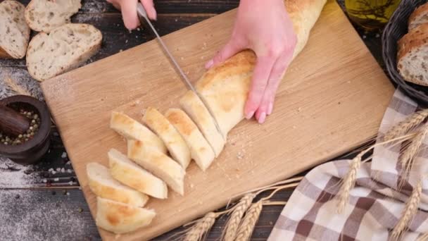 Woman Slicing Fresh Baguette Bread Wooden Cutting Board — Stockvideo